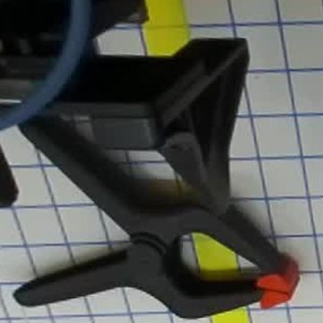 Plastic clamp — receiver lost its grip after release; final placement unconfirmed.